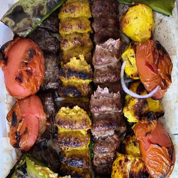 Grilled York Kabob koobideh and chicken kabob with charred tomatoes and green peppers.
