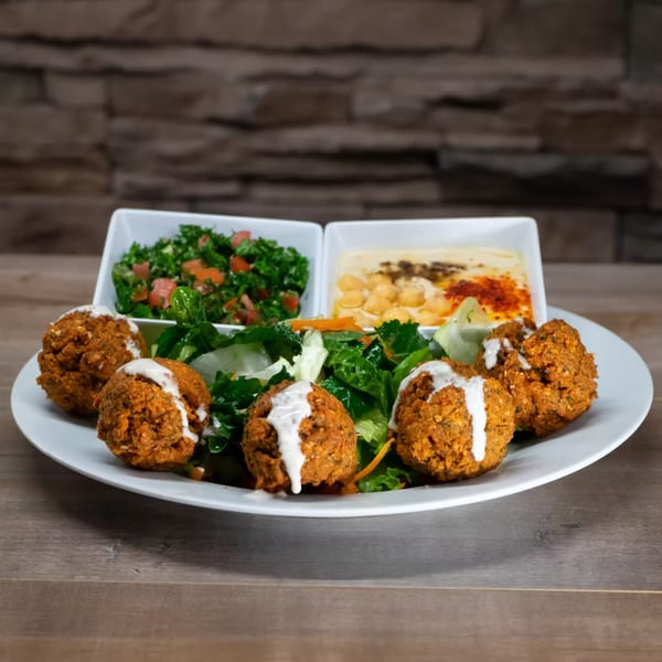 York Kabob's falafel plate with hummus, tabbouleh, and salad on a white plate.